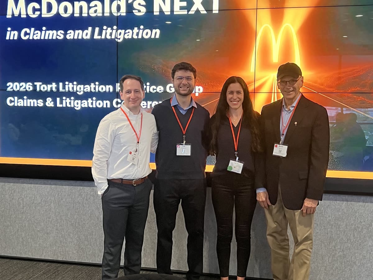 From left, Jim, Leo, Amanda, and Byron in front of a screen that reads McDonald's NEXT in Claims and Litigation, 2026 Tort Litigation Practice Group Claims and Litigation Conference.